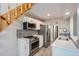 Bright kitchen with white cabinets, stainless steel appliances, and wood floors at 3539 S Fairplay Way # 10, Aurora, CO 80014