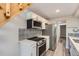 Cozy kitchen with modern appliances, white cabinets, quartz countertops, and designer backsplash at 3539 S Fairplay Way # 10, Aurora, CO 80014