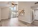 Open-concept living room with vaulted ceilings, wood floors, and a sliding glass door to the outside deck at 3539 S Fairplay Way # 10, Aurora, CO 80014