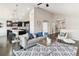 Open-concept living room flowing into a modern kitchen, featuring hardwood floors, neutral tones, and stylish decor at 22435 E Plymouth Cir, Aurora, CO 80016