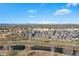 Areal view of the neighborhood, the river, and the Rocky Mountains in the distance on a partly cloudy day at 5026 S Platte River Pkwy, Littleton, CO 80123