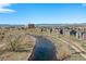 Breathtaking aerial view of the community with a river and walking path, and mountains in the distance at 5026 S Platte River Pkwy, Littleton, CO 80123