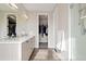 Bathroom showcasing double sink vanity, large mirrors, and open doorway to walk in closet and shower at 5026 S Platte River Pkwy, Littleton, CO 80123