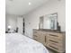 Spacious bedroom featuring a dresser and a modern style mirror on top with natural lighting at 5026 S Platte River Pkwy, Littleton, CO 80123