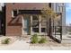 Inviting front entrance of a modern townhome with brick accents and landscaping at 5026 S Platte River Pkwy, Littleton, CO 80123