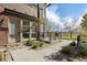 Inviting home entrance with manicured landscaping and outdoor seating area with a grill at 5026 S Platte River Pkwy, Littleton, CO 80123