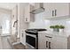 Modern kitchen featuring white cabinets, stainless steel appliances, and ample counter space at 5026 S Platte River Pkwy, Littleton, CO 80123