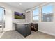 Bright living area features a wet bar, large windows, and sliding glass door to the outdoor patio at 5026 S Platte River Pkwy, Littleton, CO 80123
