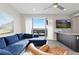 Living room featuring balcony, blue sectional sofa, leather chair, bar and an entertainment center at 5026 S Platte River Pkwy, Littleton, CO 80123