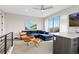 Loft featuring balcony, blue sectional sofa, leather chair, bar and an entertainment center at 5026 S Platte River Pkwy, Littleton, CO 80123