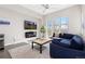 Cozy living room with modern fireplace, large windows, and comfortable seating area at 5026 S Platte River Pkwy, Littleton, CO 80123
