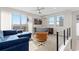 Living room featuring balcony, blue sectional sofa, leather chair, bar and an entertainment center at 5026 S Platte River Pkwy, Littleton, CO 80123