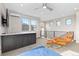 Open living area with modern decor, a wet bar, a comfortable chair, and ample natural light at 5026 S Platte River Pkwy, Littleton, CO 80123