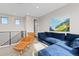 Loft featuring blue sectional sofa, leather chair, with natural light and mountain view art at 5026 S Platte River Pkwy, Littleton, CO 80123