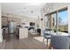 Open concept living space featuring modern kitchen, dining area, and cozy living room with fireplace at 5026 S Platte River Pkwy, Littleton, CO 80123