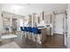 Open concept kitchen, dining and living area with wood floors, modern lighting and stylish décor at 5026 S Platte River Pkwy, Littleton, CO 80123
