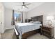 Cozy main bedroom featuring a dark wood bed frame, nightstands, dresser, and natural light at 5026 S Platte River Pkwy, Littleton, CO 80123