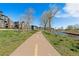 Paved path along the community, perfect for jogging, dog walking or strolling beside a river under a clear blue sky at 5026 S Platte River Pkwy, Littleton, CO 80123