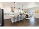 Modern kitchen with white cabinets and island at 3101 Carabiner St, Castle Rock, CO 80108