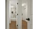 Hallway view into bright bathroom showcasing marble walls and modern fixtures at 3047 W 47Th Ave # 607, Denver, CO 80211