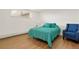 Cozy bedroom featuring wood flooring and a soothing blue color scheme with a comfy looking armchair at 3047 W 47Th Ave # 607, Denver, CO 80211