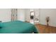 Bright bedroom featuring a large closet, french doors to the living space and wood-look floors at 3047 W 47Th Ave # 607, Denver, CO 80211
