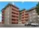 Apartment building exterior with multiple balconies and ample parking at 3047 W 47Th Ave # 607, Denver, CO 80211