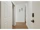 Well-lit hallway featuring fresh paint, wood floors and access to other rooms at 3047 W 47Th Ave # 607, Denver, CO 80211