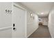 Hallway featuring unit 607 door, updated lighting, and neutral carpeting at 3047 W 47Th Ave # 607, Denver, CO 80211