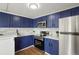 Modern kitchen boasting stainless steel appliances, sleek countertops, and dark blue cabinets at 3047 W 47Th Ave # 607, Denver, CO 80211
