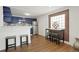 Charming kitchen with bold blue cabinetry, stainless steel appliances, and a breakfast bar at 3047 W 47Th Ave # 607, Denver, CO 80211