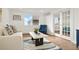 Cozy living room with a plush sofa, accent chair, and view from large window at 3047 W 47Th Ave # 607, Denver, CO 80211