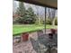 Covered patio overlooking a well-maintained lawn, ideal for enjoying the outdoors at 6454 S Nelson Way, Littleton, CO 80127