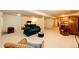 Finished basement with multiple seating areas, a treadmill, and plenty of space at 6454 S Nelson Way, Littleton, CO 80127