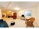 Basement featuring a sitting area, television, and storage; perfect for extra living space at 6454 S Nelson Way, Littleton, CO 80127
