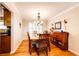 Elegant dining room features hardwood floors, a wooden table with chairs, and a decorative chandelier at 6454 S Nelson Way, Littleton, CO 80127