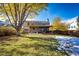 View of home's exterior from the yard, featuring a covered patio at 6454 S Nelson Way, Littleton, CO 80127