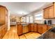 Spacious kitchen features granite countertops, wooden cabinets, and a seamless flow into the living area at 6454 S Nelson Way, Littleton, CO 80127