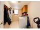 Functional laundry room with washer, dryer, storage, and shelving at 6454 S Nelson Way, Littleton, CO 80127