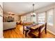 Cozy living room features a brick fireplace, hardwood floors, and natural light at 6454 S Nelson Way, Littleton, CO 80127