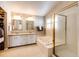 Main bathroom with dual sinks, soaking tub, and glass-enclosed shower at 6454 S Nelson Way, Littleton, CO 80127