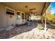 Covered brick patio with outdoor seating, perfect for relaxing or entertaining guests at 6454 S Nelson Way, Littleton, CO 80127