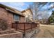 Charming brick home featuring a wooden deck perfect for outdoor relaxation and entertaining at 7288 S Sundown Cir, Littleton, CO 80120