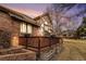 Charming brick home featuring a wooden deck perfect for outdoor relaxation and entertaining at 7288 S Sundown Cir, Littleton, CO 80120