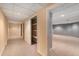 Basement hallway with closet and doorway to a large carpeted room with recessed lights at 7288 S Sundown Cir, Littleton, CO 80120