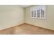 Neutral bedroom featuring carpet flooring, a large window with shutter blinds, and light-colored walls at 7288 S Sundown Cir, Littleton, CO 80120