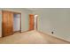 Bedroom featuring carpeted floors, closet with sliding doors, and wood trim with neutral paint at 7288 S Sundown Cir, Littleton, CO 80120