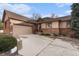 Charming single-Gathering home featuring a brick exterior, two-car garage, and well-manicured front yard at 7288 S Sundown Cir, Littleton, CO 80120
