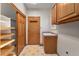 Laundry area with tile floors, cabinets, and a utility sink near the back door and closet at 7288 S Sundown Cir, Littleton, CO 80120