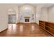 Open-concept living room with fireplace and access to patio at 7288 S Sundown Cir, Littleton, CO 80120